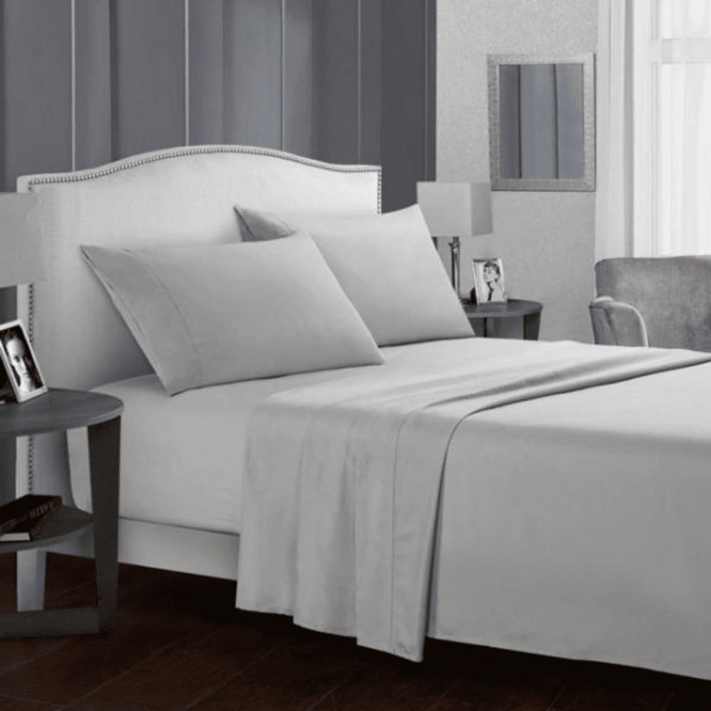 Luxury 5 star hotel Bed Sheet set on a modern upholstered bed in guest room.
