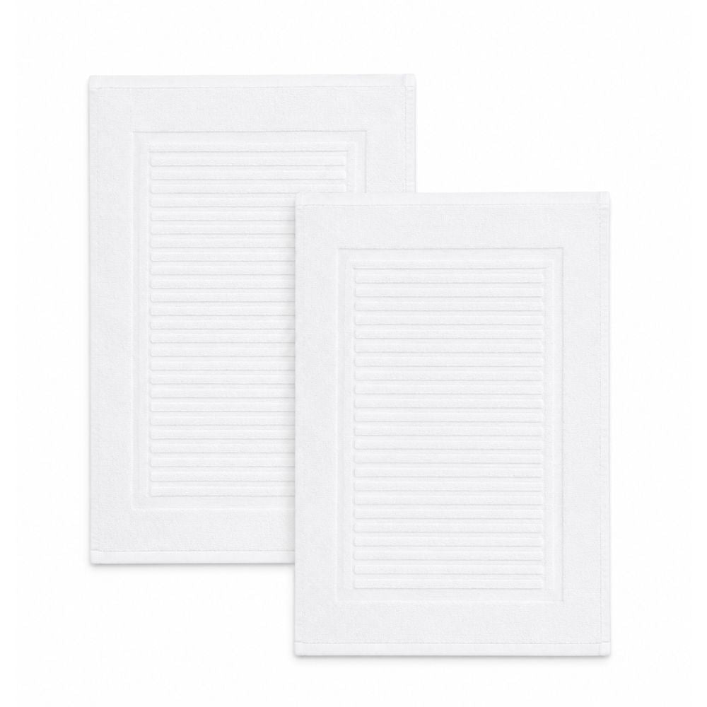 White ribbed terry bath mat with an absorbent textured centre and neatly finished border, ideal beside showers, bathtubs and vanities.