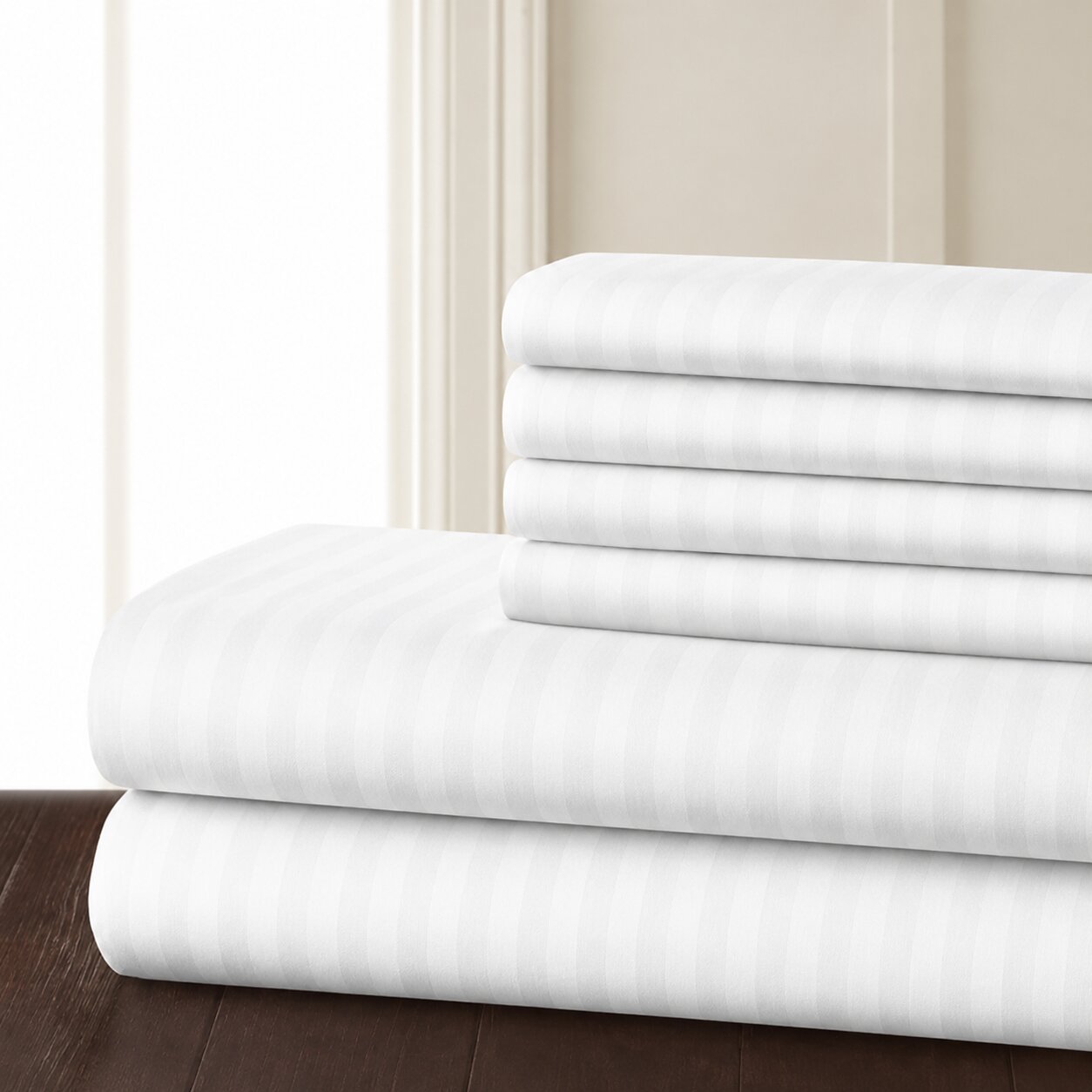 White hotel bed sheet set with striped fabric, neatly folded for hospitality bedding and guest room use.