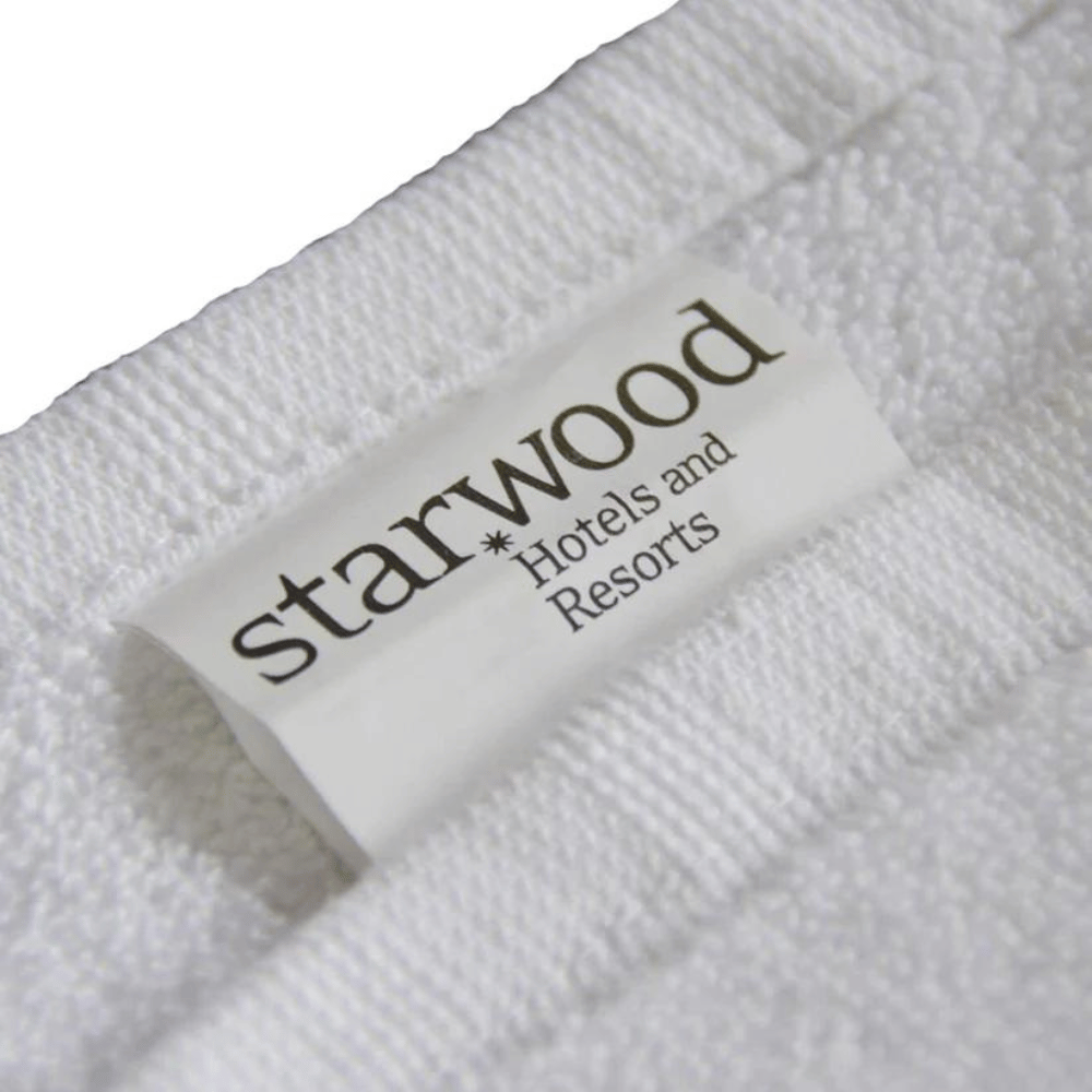 White cotton hand towel displayed neatly to emphasize softness, durability, and refined construction