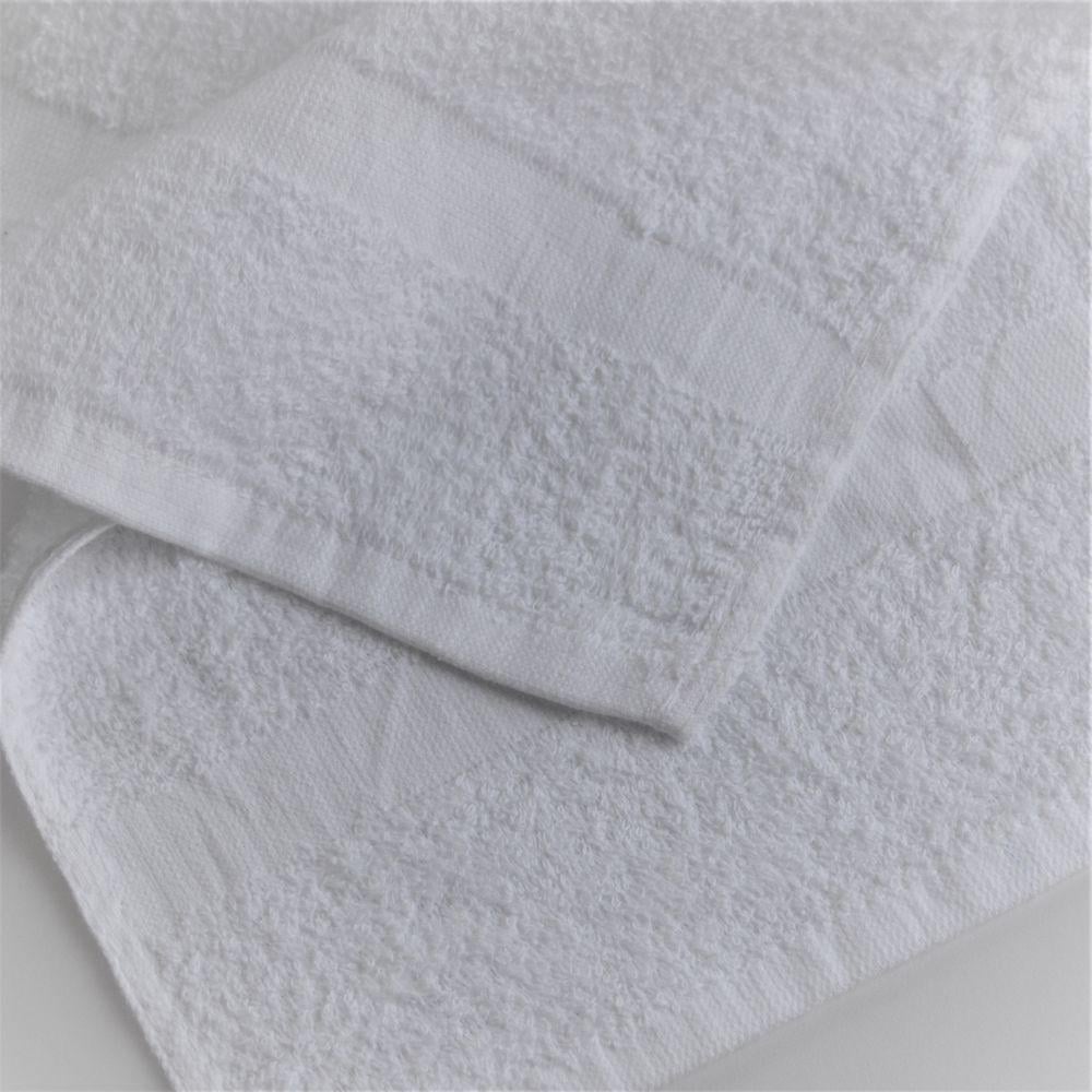 White terry hand towel displayed neatly to emphasize durability, colorfast quality, and refined finish