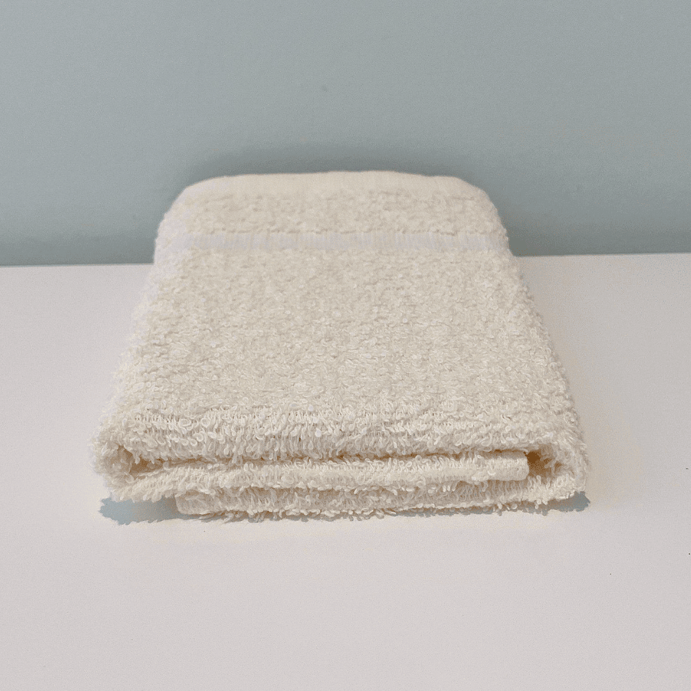 Front white 12x12" spa and hotel washcloth, soft, quick-drying, and durable—perfect for sensitive skin in hospitality settings.