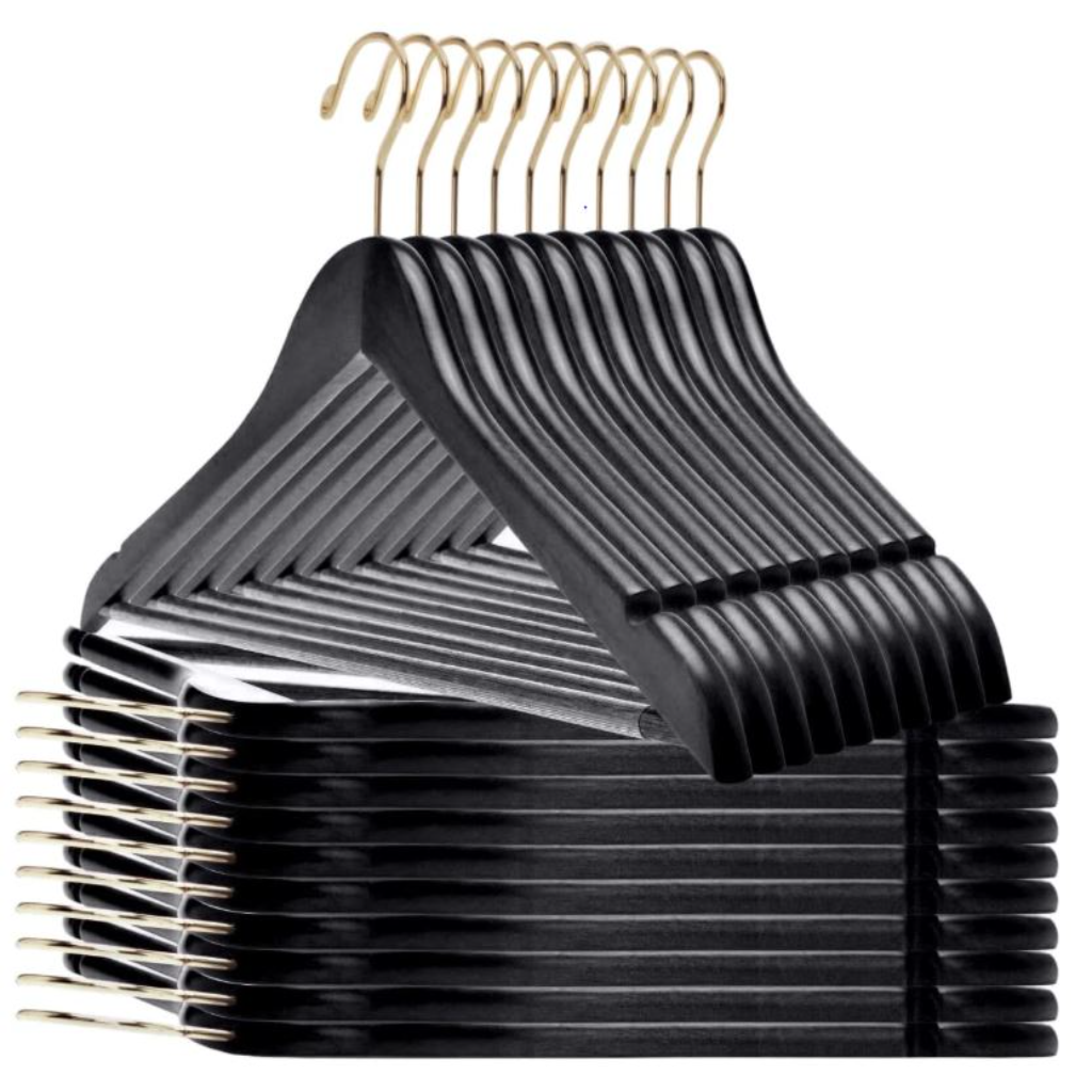 Set of black wooden hangers with a golden tint for hotel closets and guest room organization.