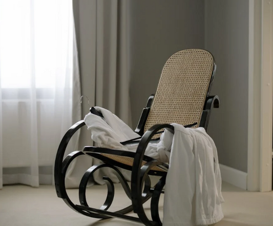 white cotton bathrobe draped over vintage rocking chair in a luxury hotel room