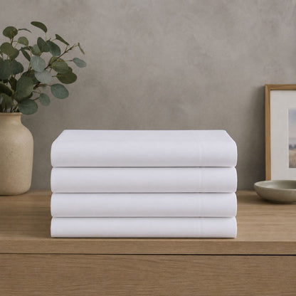 Stack of neatly folded white microfiber flat sheets with a soft, smooth finish, ideal for fresh and comfortable everyday bedding.