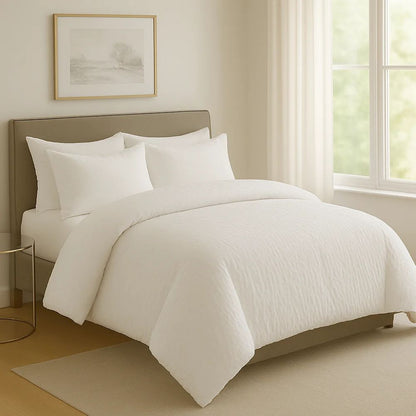 White crinkle prewash duvet styled in a bright bedroom with white pillows for a warm, cozy and contemporary bedding look.