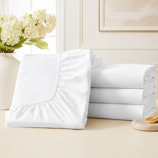 CH Series Premium white fitted sheet with elasticized corners and neatly folded bedding, designed for a smooth, secure mattress fit.