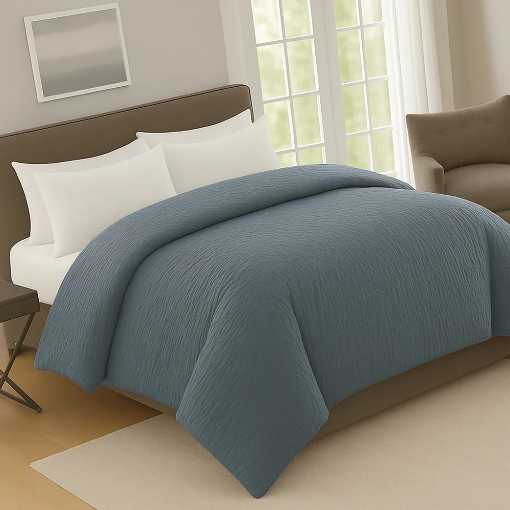 Bluedusk crinkle prewash duvet on a neatly made bed with white pillows, adding warmth and rich colour to the bedroom décor.