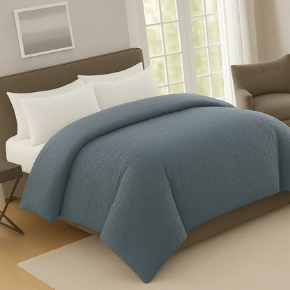 Bluedusk crinkle prewash duvet on a neatly made bed with white pillows, adding warmth and rich colour to the bedroom décor.