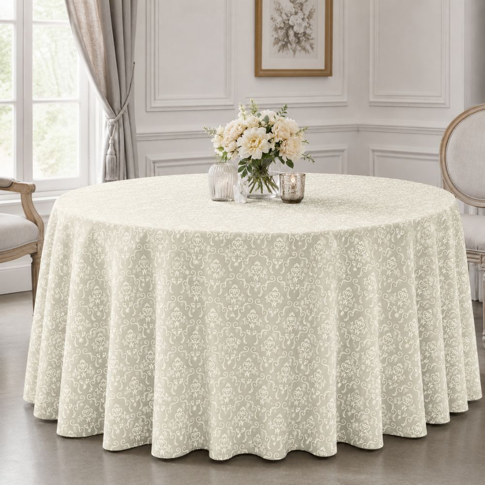 Ivory patterned round tablecloth displayed on an elegant round table with floral centrepiece in a bright, classic dining room.