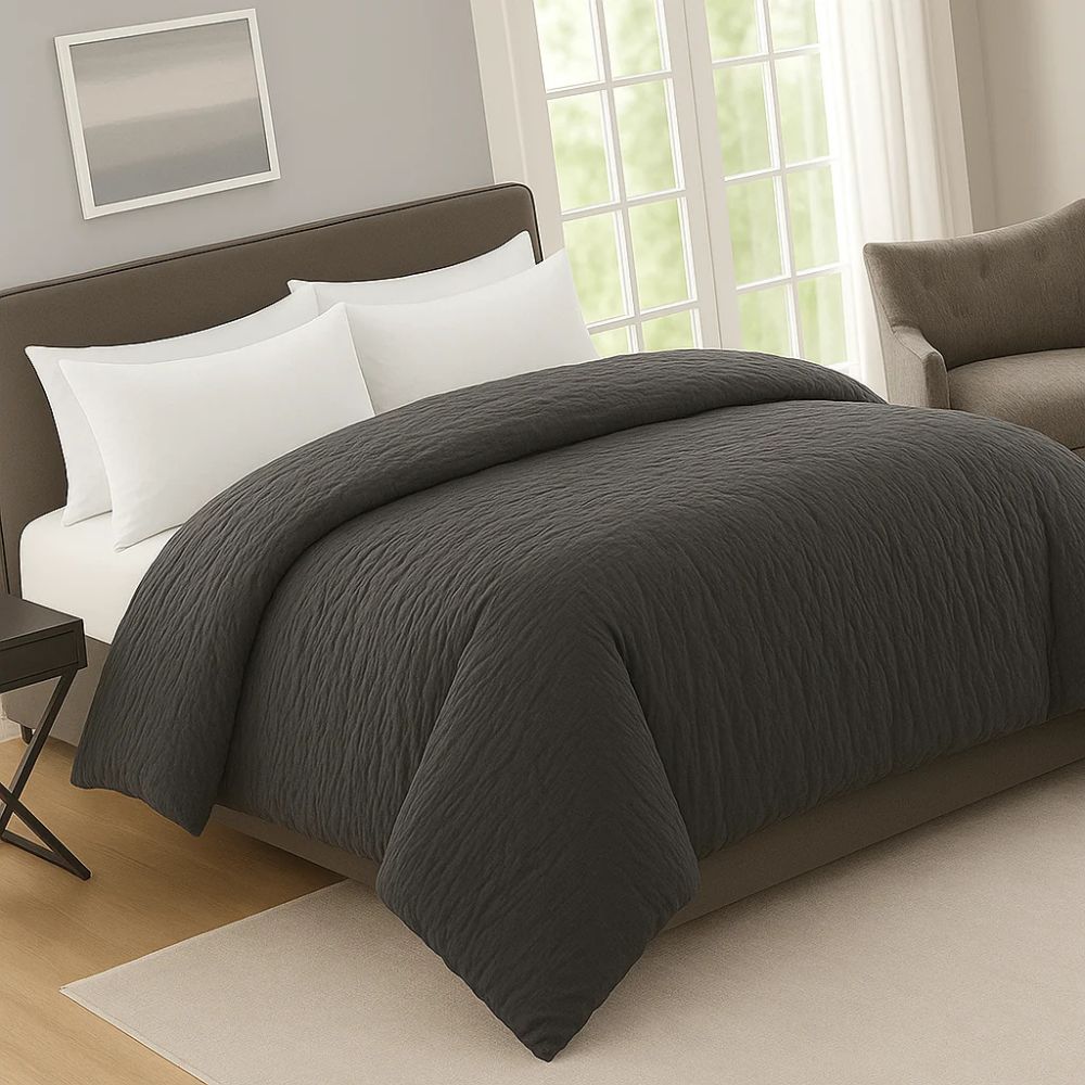Charcoal gray prewash duvet on a modern bed with white pillows, creating a soft, calming and elegant bedroom atmosphere.
