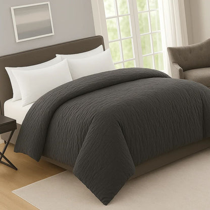 Charcoal gray prewash duvet on a modern bed with white pillows, creating a soft, calming and elegant bedroom atmosphere.
