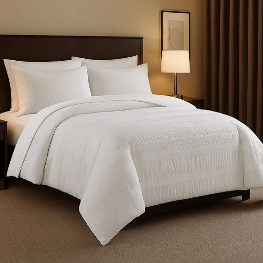 White moselle cotton duvet on a modern bed with crisp white pillows for a refined and comfortable bedroom look.