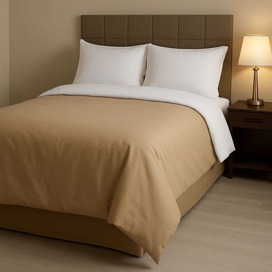 Warm almond comforter paired with crisp white pillows and bedding for a cozy, neutral and inviting bedroom appearance.