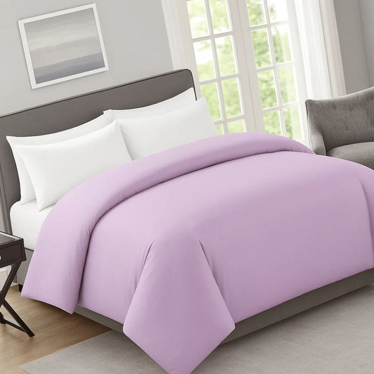 Lavender comforter styled on a modern bed with white pillows for a soft and calming bedroom appearance.