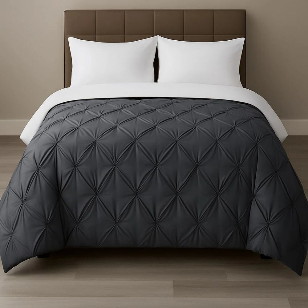 Charcoal grey pinch-pleat comforter paired with white pillows on a modern bed for a bold, sophisticated bedroom look.