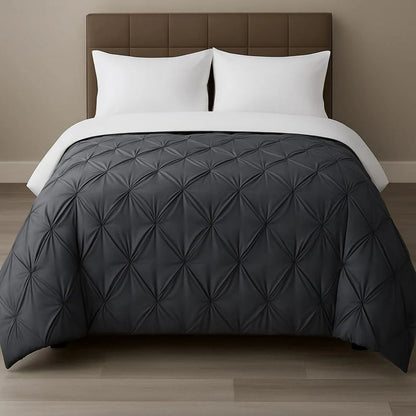 Charcoal grey pinch-pleat comforter paired with white pillows on a modern bed for a bold, sophisticated bedroom look.