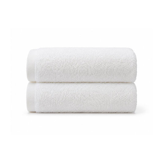 Soft white bath towel laid flat on a clean white background, showing its smooth terry texture and simple border for everyday bathroom use.