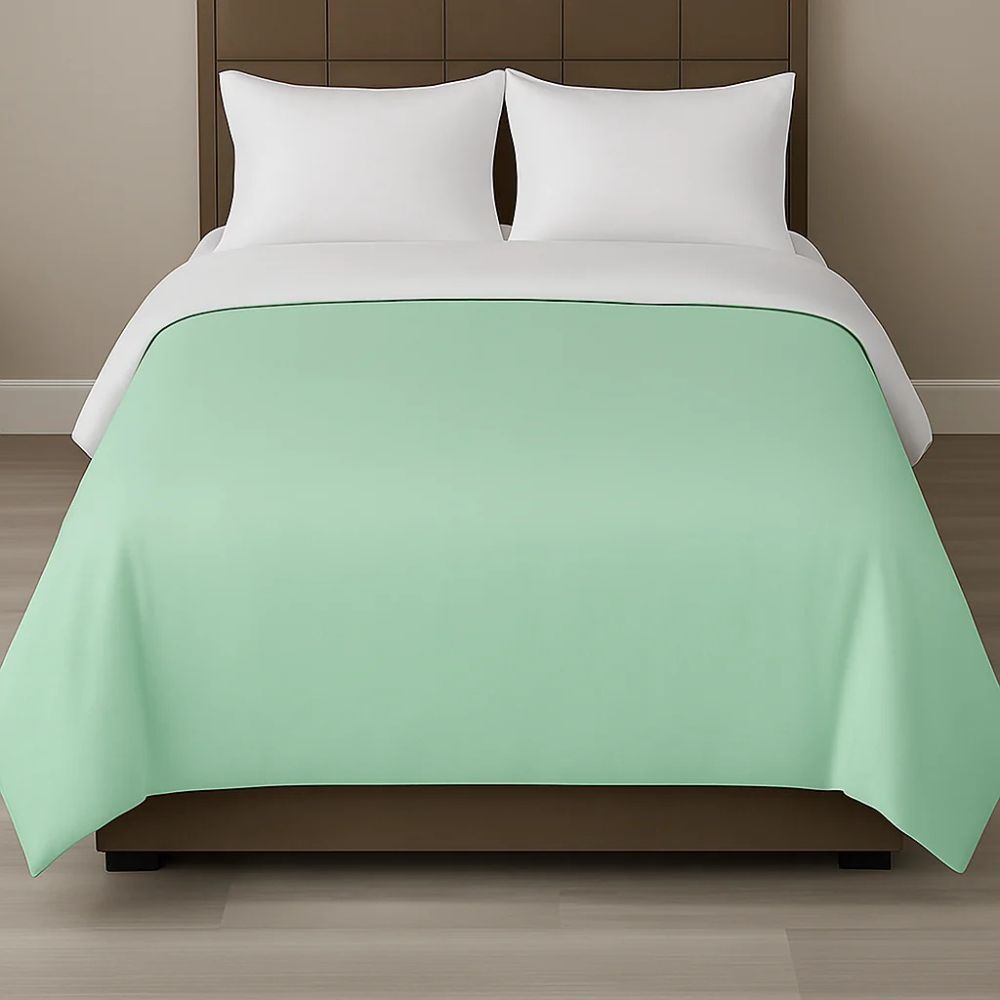 Mint green duvet cover styled on a modern bed with white pillows for a fresh, calming and contemporary bedroom look.