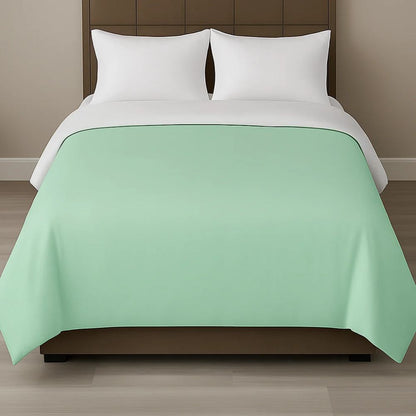 Mint green duvet cover styled on a modern bed with white pillows for a fresh, calming and contemporary bedroom look.