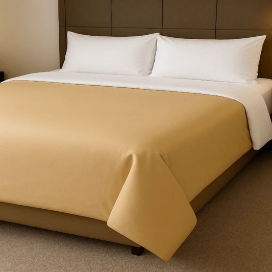 Golden beige duvet cover displayed with crisp white pillows for a warm and refined bedroom appearance.