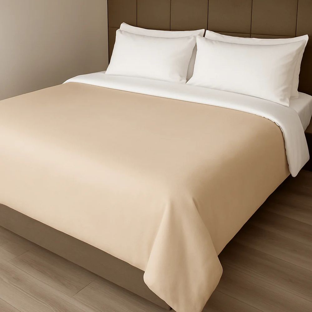 Light beige duvet cover styled on a neatly made bed with white pillows for a soft, neutral and elegant look.