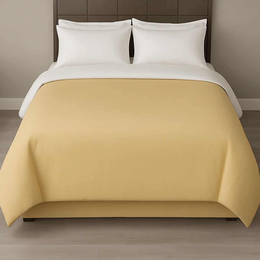 Sand-coloured duvet cover styled with white pillows for a clean, neutral and inviting bedroom appearance.