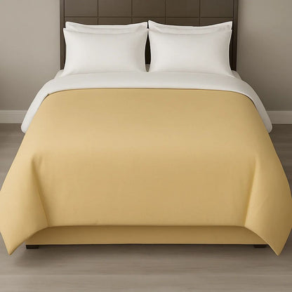 Sand-coloured duvet cover styled with white pillows for a clean, neutral and inviting bedroom appearance.