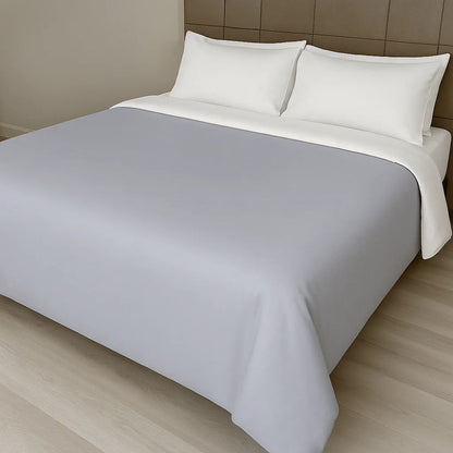 Light grey duvet cover displayed on a modern bed with white pillows for a clean and versatile bedroom style.