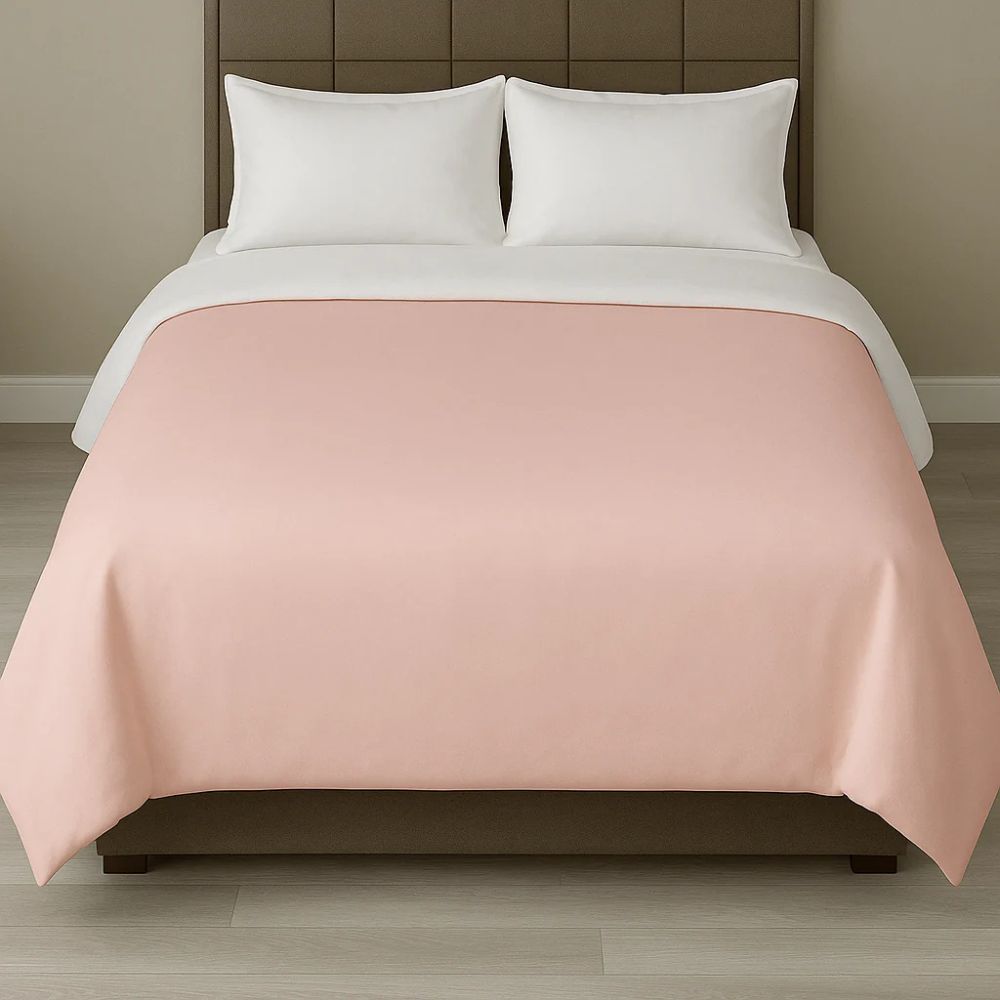 Soft blush pink duvet cover displayed with white pillows for a gentle, elegant and relaxing bedroom style.