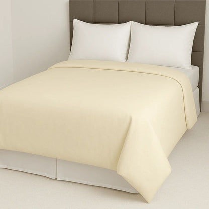 Soft cream yellow duvet cover paired with crisp white pillows for a warm, subtle and inviting bedroom style.