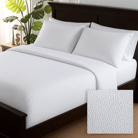 White textured duvet cover styled on a neatly made bed with matching white pillows for a clean, fresh and elegant bedroom look.