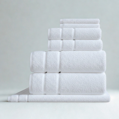 Thick cotton bath towel set rolled and stacked for bathroom display, highlighting absorbency and texture.