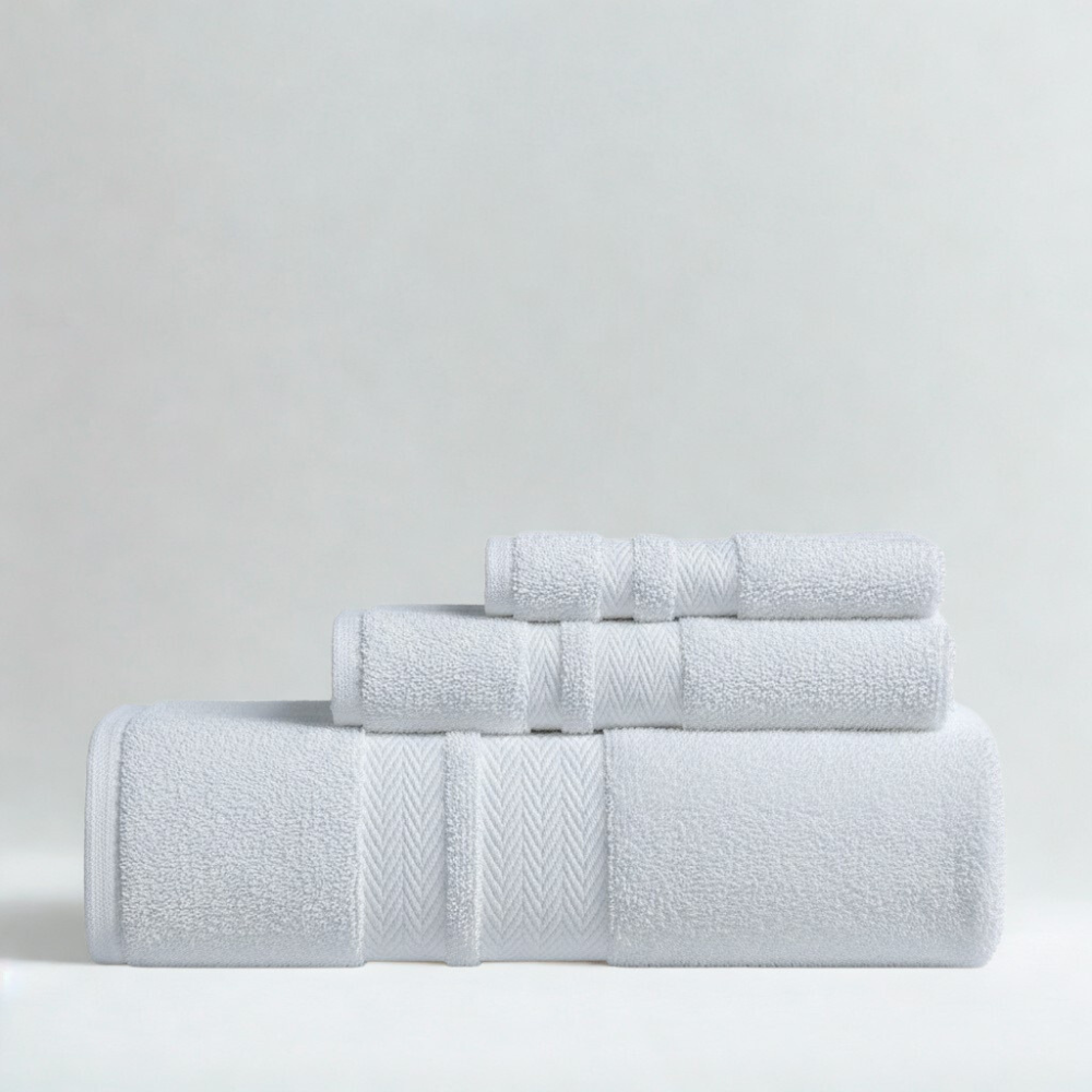 Plush cotton towels arranged neatly, showcasing exceptional softness and a clean, luxurious bathroom look