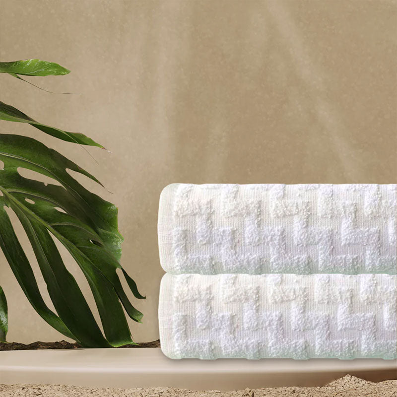 Textured white towel and plant