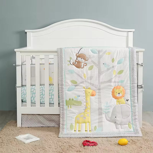 White crib with colorful animal-themed blanket.
