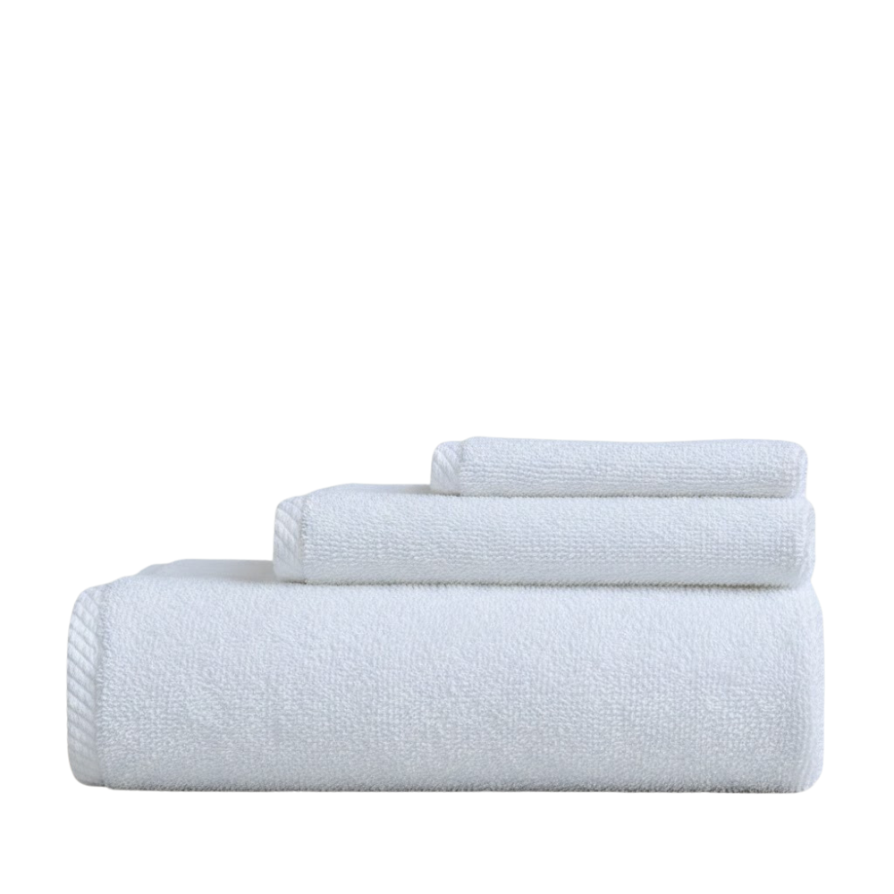 Plush cotton towels arranged with a matching bath mat, offering a soft, absorbent feel and a refined spa-inspired look
