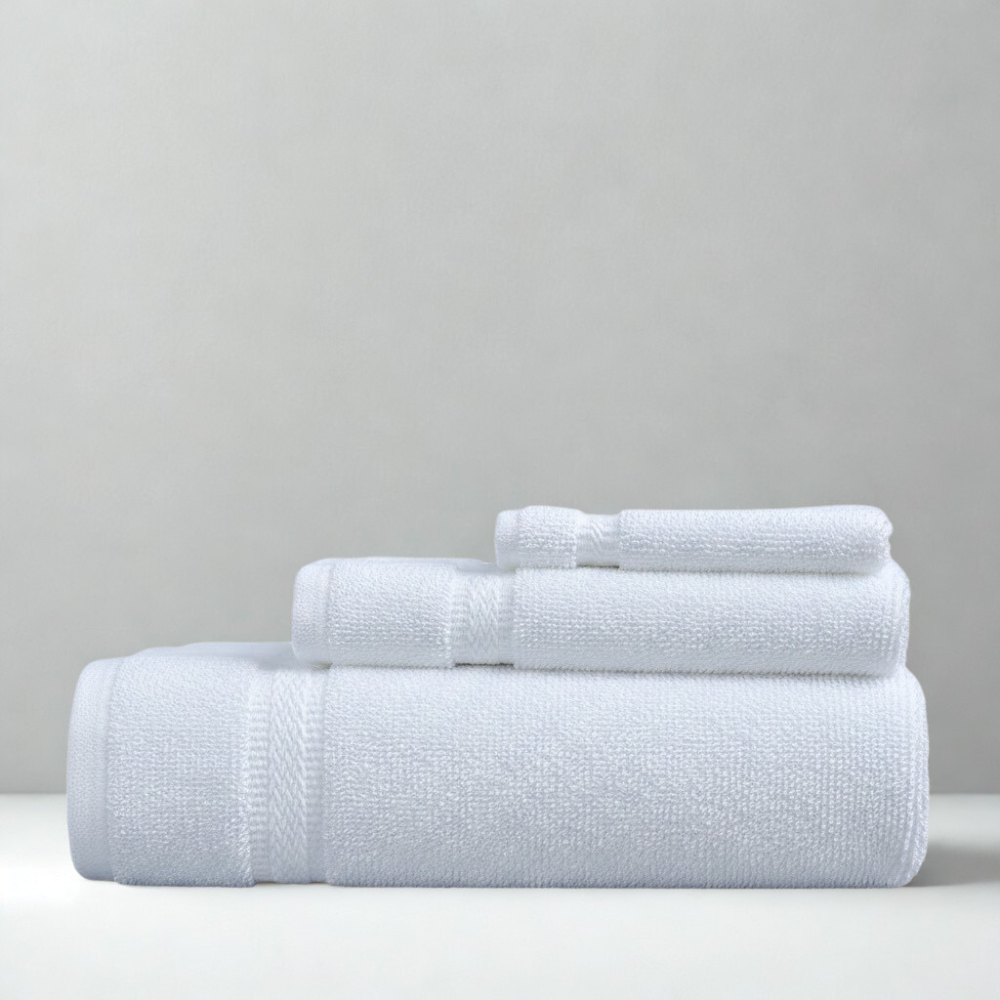 Stack of white cotton towels highlighting a thick, absorbent weave and a timeless bathroom look