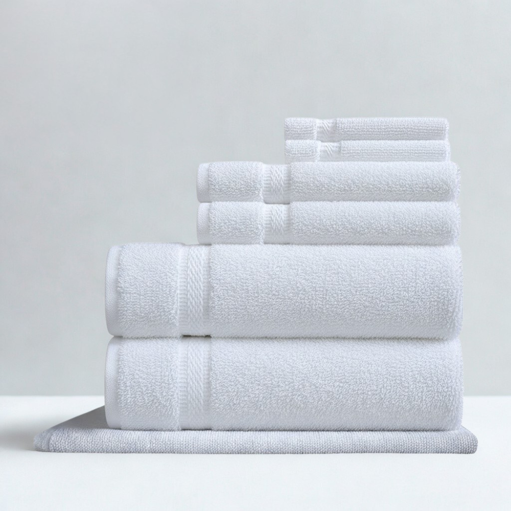 Cotton hand towel displayed flat, featuring a refined border and a soft, absorbent surface