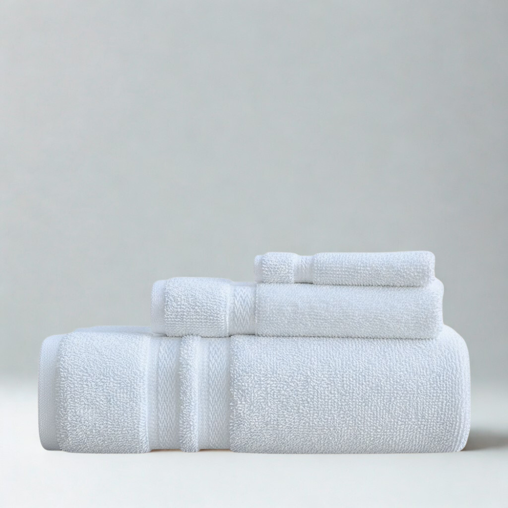 Layered cotton towels arranged to show thickness, softness, and a premium spa-inspired appearance