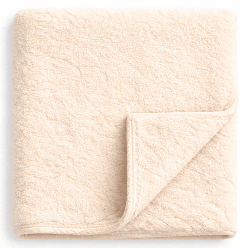 Plush ivory fleece blanket with clean border, ideal for hotel rooms, resorts and Airbnb spaces.