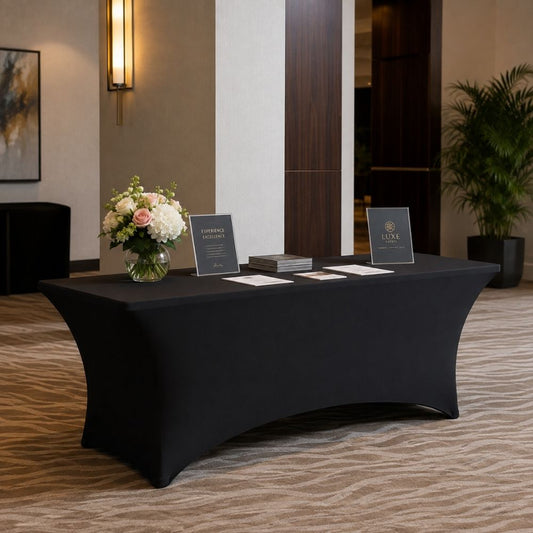 Black stretch spandex table cover styled on an elegant event display table with flowers and décor for parties, weddings and special occasions.
