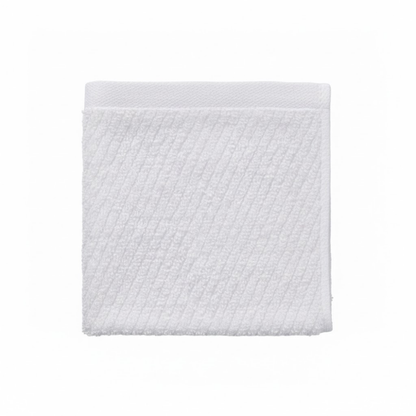 Close-up of a white cotton washcloth showcasing a diagonal stitch pattern and a smooth, luxurious finish