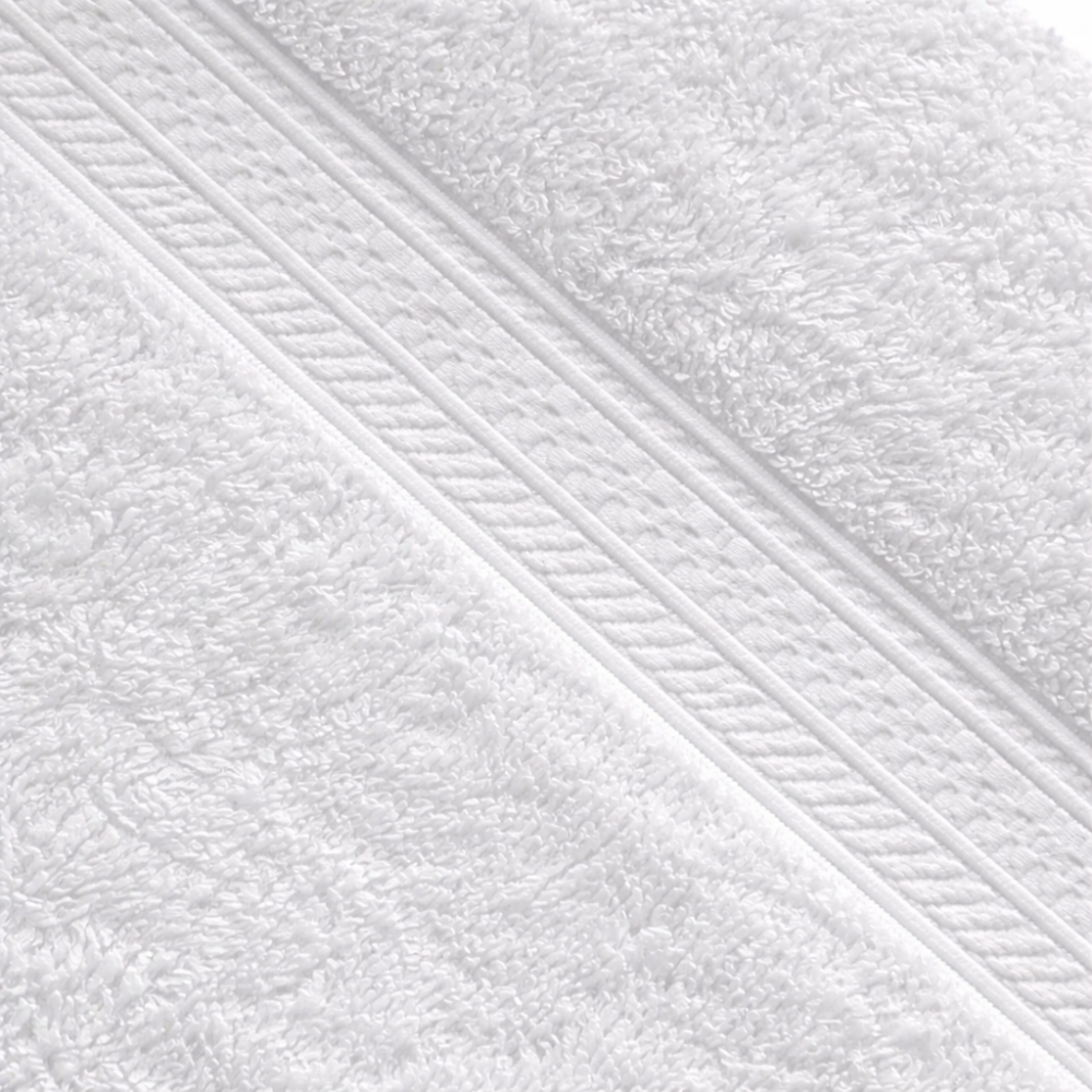 Close-up of a cotton washcloth showcasing a dense, luxurious weave and a subtle dobby border detail