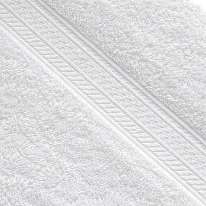 Close-up of a cotton washcloth showcasing a dense, luxurious weave and a subtle dobby border detail