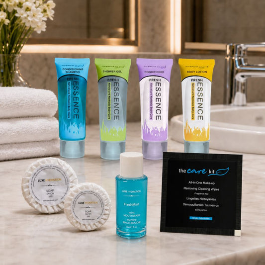 Fresh Essence toiletries displayed in an elegant bathroom with soaps, FreshMint mouthwash and makeup remover wipe for complete guest care.