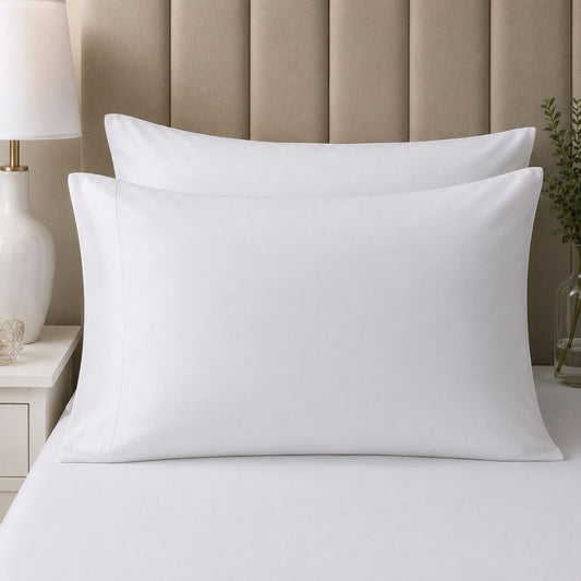 Two white CH Series Premium pillowcases arranged one in front of the other on a modern bed for a crisp, comfortable bedroom look.