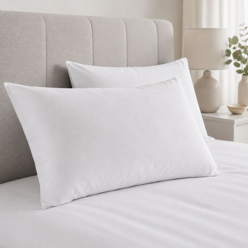 White microfiber pillowcases arranged on a modern bed, offering a soft, smooth feel and clean finish for comfortable everyday sleeping.