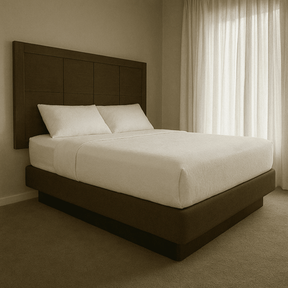Elegant hotel bed with brown upholstered base, crisp white linens, perfect for hospitality use.