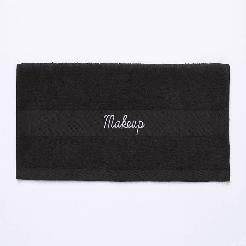 Premium Turkish black makeup towel for hotels, horizontal view showing embroidered band, ideal for guest rooms and spas.